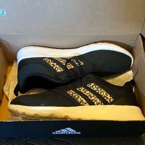 Adidas black/white w/ classic three stripes in leopard print. Gently used.